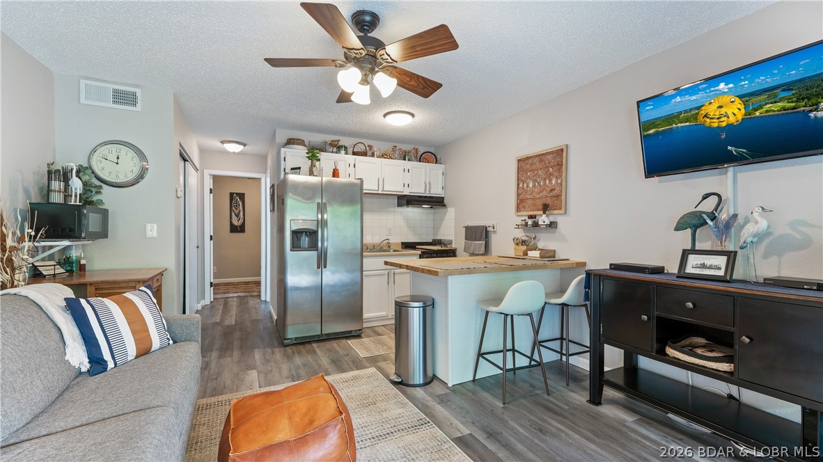 Turn-key lakefront living in the gated Southwood Shores complex on the 12 mile marker in Four Seasons. This 1 bedroom, 1 bathroom ground floor condo offers easy access to the water from the lakeside patio and a private setting that looks directly at the lake instead of nearby docks. Boat slips are available, making it a great option for enjoying the Lake lifestyle full-time or part-time. Recent updates include newer flooring, fresh paint, newer water heater, updated bar area, new bedroom mattress, newer patio railing, and an HVAC system that is only 5 years old. The shaded lakeside patio creates a comfortable outdoor space to relax during the summer months, while the ground floor location helps keep utility costs low. Southwood Shores amenities include a lakeside pool, indoor pool, tennis and pickleball courts, playground, boat ramp, boat trailer parking, gated entry/exit, and more. Conveniently located near Lake House 13 by water and The Office and Angels Mexican by land, while entertainment, shopping, and golf are also just a short drive away. This condo offers low-maintenance lake living in one of the Lake’s most desirable condo complexes.