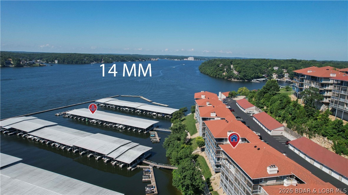 Stunning Main Channel Views & Complete Package! Experience the ultimate lake lifestyle in this beautifully updated 3-bedroom, 3-full-bath Palisades condo. Immediately upon entering, your eyes are drawn to the fantastic, sweeping views of the main channel. The heart of the home features an open galley kitchen that flows seamlessly into the living area, highlighted by modern wood-vinyl flooring in a clean, stylish white and grey color palette. Step outside to relax or entertain on the screened-in patio—the perfect spot to enjoy the lake breeze without the bugs. This unit offers the complete package: it comes fully furnished, includes a 12x32 boat slip equipped with a double drive-on PWC lift, and features a private parking space & includes your very own garage directly across from unit. Perfect for full-time living, a weekend retreat, or an investment property!