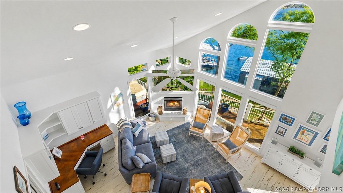 Could you see yourself overlooking the beautiful 2mm of the Gravois Arm? This home features a primary suite on each floor, creating private accommodations for family and guests alike. Recent updates in 2022 add fresh style and functionality throughout. The heart of the home is the beautifully appointed kitchen, complete with a massive island, custom cabinetry , quality appliances, and a built-in ice maker. A charming bar area tucked beside the stairway adds even more space to gather and unwind. Main-level bedrooms, both offering private balcony access. The lower level is made for relaxation, featuring a cozy gas fireplace and walkout access to a spacious lakeside deck. Outside, soak in the hot tub while taking in spectacular sunsets and tranquil lake views. Large covered dock with two boat slips and 2 PWC lifts. Conveniently located just down O road and minutes from some of the Lake of the Ozarks most popular waterfront restaurants, bars, and entertainment destinations, this exceptional property combines luxury, recreation, and convenience in one unforgettable package. Call us for a private showing today!