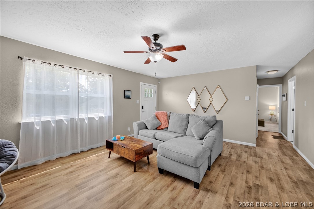 Welcome home to 131 Poplar in Camdenton, MO! This charming, move-in ready 2-bedroom, 1-bathroom home offers just under 1,200 square feet of comfortable, single level living space. The true heart of this home is the massive, ultra-spacious kitchen, which is completely flooded with natural light from an abundance of large windows. This bright and airy kitchen flows seamlessly into an oversized living room, creating a highly functional layout with a wonderfully open feel. Step outside to your own private retreat! The level city lot features a fully fenced backyard complete with two raised garden beds and an established fire pit area that is perfect for outdoor entertaining. Best of all, you are just a short, convenient walk away from historic downtown Camdenton.