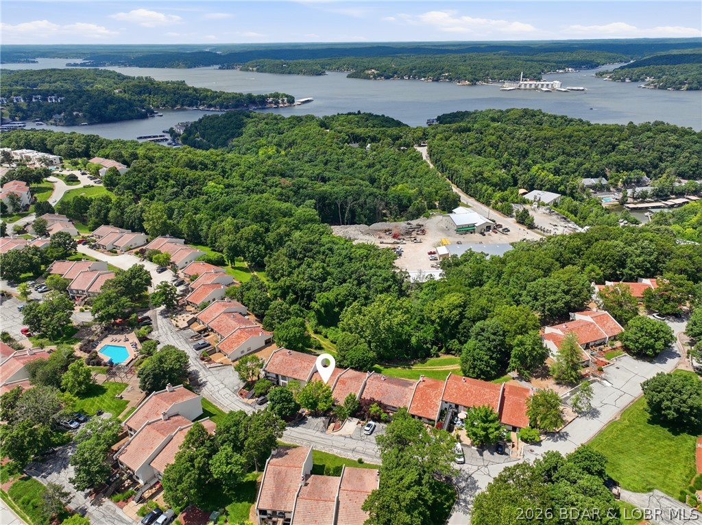 Experience the best of Lake living in this beautifully remodeled 2-bed, 2-bath townhouse-style condo in the highly desirable Horseshoe Bend area. Offering 1,251 sq ft of living space plus a 270-sq-ft screened balcony, this single-level residence combines comfort, privacy & convenience. A enclosed front patio provides the perfect space for outdoor dining, entertaining, or relaxing after a day on the water. With no upstairs neighbors, you'll enjoy a peaceful setting with views of the surrounding woods & lake. The primary suite features a walk-in closet, double vanity, separate shower & jetted tub. The kitchen includes a charming garden window & the washer/dryer are included for added convenience. The screened balcony is an ideal spot for morning coffee or evening relaxation while enjoying the Ozark scenery. Located in the sought-after Osage Vistas community, owners enjoy access to 6 pools, walking trails & beautifully maintained grounds. Adjacent to Regalia Hotel & Conference Center, you'll be close to dining, entertainment & resort-style amenities. Golf courses, marinas, waterfront restaurants, shopping & the famous Bagnell Dam Strip are all just minutes away.