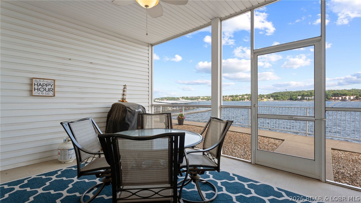 Discover the best of Lake of the Ozarks at Isla Del Sol. Located at the 4MM, this remarkable 3-bedroom, 2-bathroom turnkey condo offers a "million-dollar view" stretching for miles. This lower-level, walk-out unit combines luxury and convenience, featuring elevator & handicapped access and a coveted 12'x32' boat slip in a prime cove-side location. The exquisite lakeside master suite pampers you with a spacious walk-in closet, dual vanities, and a lavish walk-in shower. Relax on the screened-in back porch, where you can take in unique views of the iconic Bagnell Dam and the scenic main channel. Life at Isla Del Sol feels like a permanent vacation. The community offers top-tier amenities, including a stunning zero-entry pool with water fountains, professional BBQ grills, and two inviting gas fire pits for evening gatherings. Whether you are looking for a full-time residence or a high-end getaway, this condo delivers the ultimate lake lifestyle.