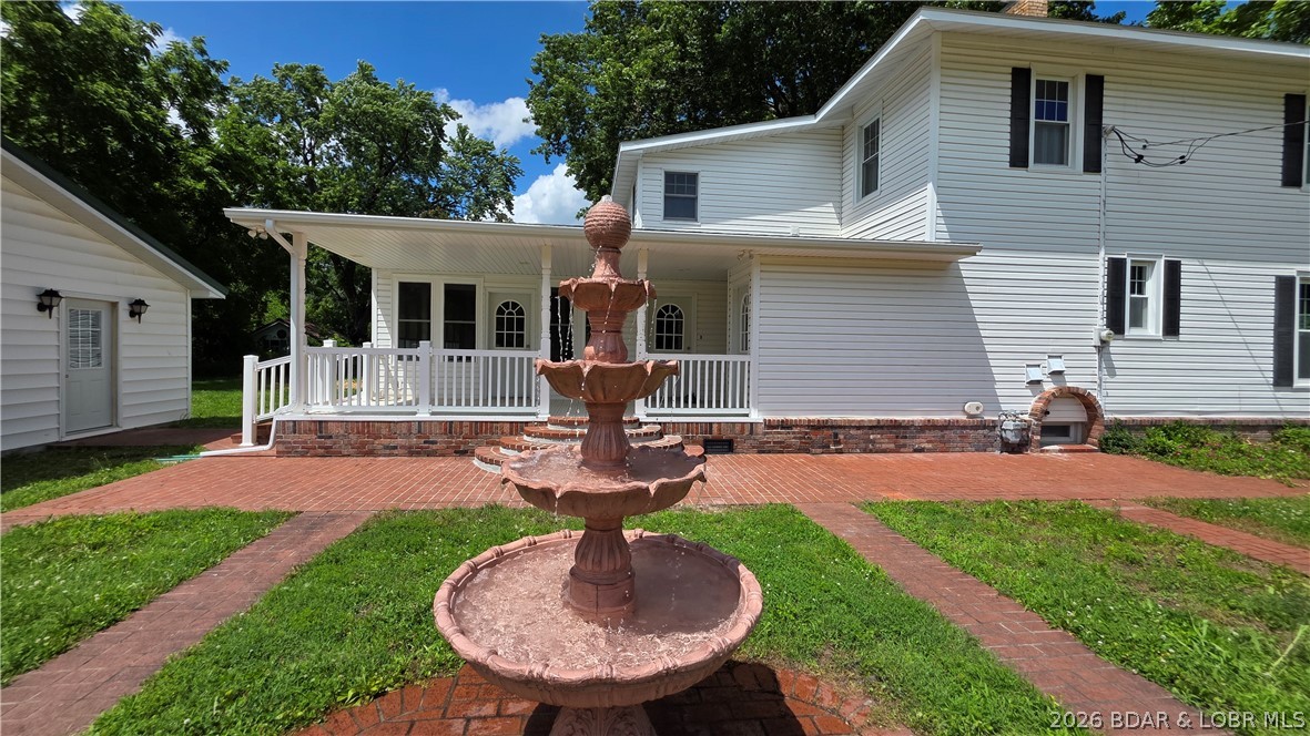 Delightful turn-of-the-century home beautifully updated while preserving its timeless charm! This inviting property features a spacious primary suite complete with a private bath, washer/dryer, walk-in closet, & additional closet space for extra storage. The oversized primary bedroom showcases a stunning wall of windows & private deck overlooking the tranquil water fountain, creating the perfect retreat. You will love the beautiful woodwork in the open living room with big windows for natural light. The large formal dining room is wonderful for families to gather. Enjoy peace of mind with new appliances, many new windows, updated flooring, some new plumbing, electric fireplace and numerous additional improvements throughout the home. Stairs to attic for additional storage and a partial basement as well. Sip your morning coffee or unwind in the evening on the charming covered front porch and enjoy the neighborhood atmosphere. Outside, you'll find a 3-car garage/workshop, storage shed, and a location that is hard to beat, all within walking distance to shopping, restaurants, banking and additional businesses. Character, comfort, and convenience wrapped into one delightful property!