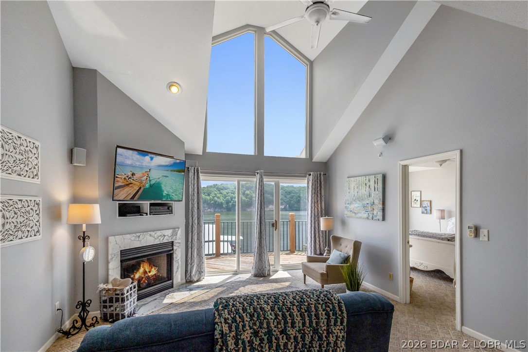 Looking for peaceful relaxation at Lake of the Ozarks, here it is! Overlooking the tranquil state park on the Grand Glaize Arm, an area known for quieter waters, exceptional fishing, boating, and endless water activities. This 3-bedroom, 3 full-bath condo offers convenience and comfort, with a 12x30 boat slip included. Inside, you’ll find a two-level condo with a spacious loft and second suite. The open-concept layout is beautifully decorated, offering breathtaking views, afternoon shade, and a clear view of your dock. Enjoy peace of mind with a newer HVAC system, a water heater that is only a year old, and appliances that are just two years old. Both front and lakeside decks have been replaced. The included boat lift, only four years old, enhances your boating experience. Community amenities feature a pool, clubhouse with workout area, on-site manager, and a pet-friendly atmosphere. Perfect for full time living, a great weekend getaway or investment property, as short term rentals are allowed. Nestled in the heart of Lake of the Ozarks State Park, you’ll appreciate abundant wildlife and the perfect blend of nature and lake living.
