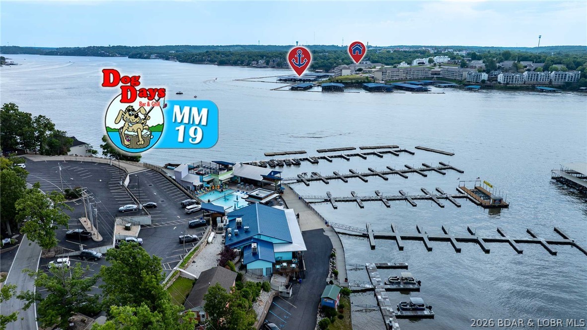 The BEST main channel views at Lands End! If you’ve been waiting for a truly standout condo at one of the Lake’s most sought-after complexes, this is the one that rises above the rest. This beautifully updated unit offers 7.5 miles of breathtaking panoramic lake views & oversized 16x48 boat slip visible right from the condo. Inside, the open-concept layout was designed for entertaining & comfortably hosting family/guests, featuring updated LVP flooring, modern lighting, fresh paint, smart TVs, newer HVAC & water heater, plus stylish furnishings included. The kitchen offers stainless appliances, custom cabinetry, large island seating, and flows seamlessly into spacious living area w/custom stone fireplace. The screened-in deck is where you’ll want to spend every moment! Strong 5-star rental history adds investment appeal. Lands End amenities include 2 heated pools, lazy river, clubhouse w/fitness center, playground, basketball court, lighted boardwalk, elevator access/zero stairs to the unit. With multiple units currently available at Lands End, buyers should pay attention to the ones w/truly exceptional views, updates, slip size, and rental history—this one checks every box!