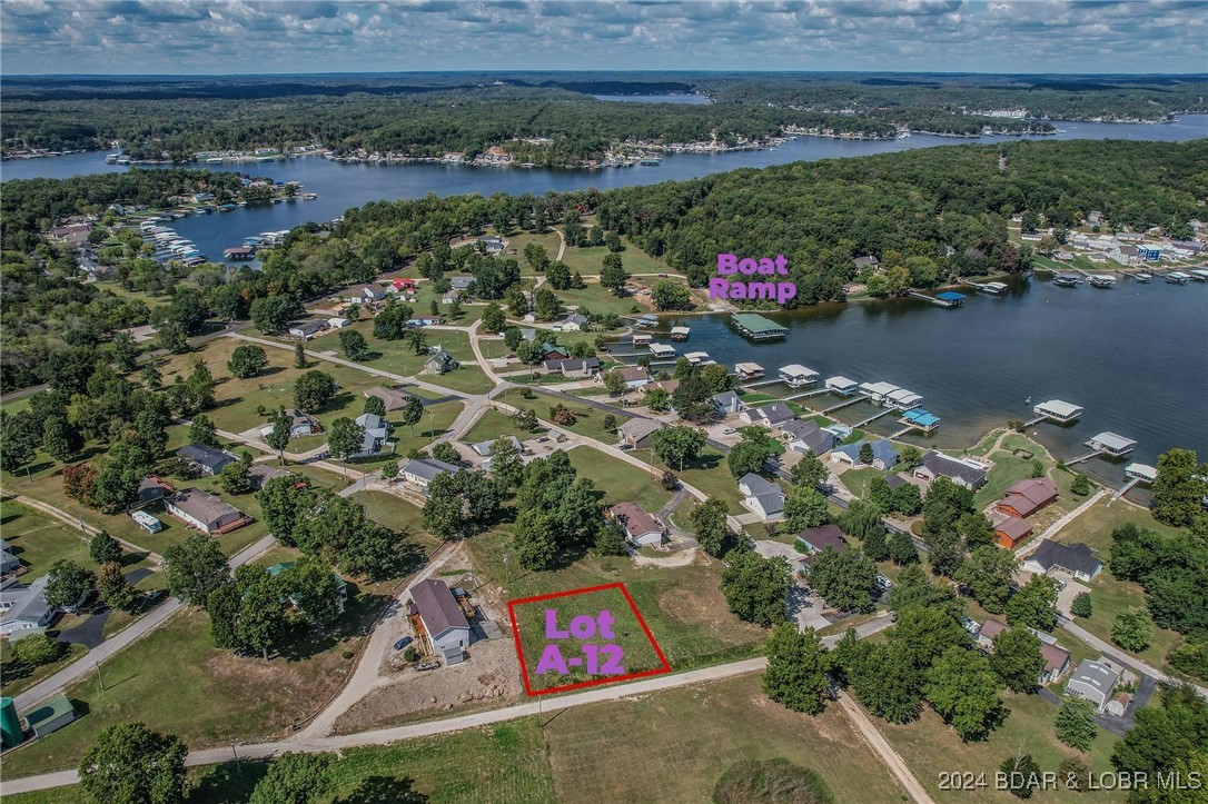 Lot A-12 in Johnsons Bay subdivision is a corner lot with a good view of the lake, this lot is perfect for that walk out lower-level home. Enjoy lake access via subdivision boat ramp. Hard to find lots this cheap with water and sewer hook ups! Several parcels have sold this year making Johnsons Bay a HOT area! Located at the Gravois 3mm super close to many of the lakes hottest waterfront attractions!