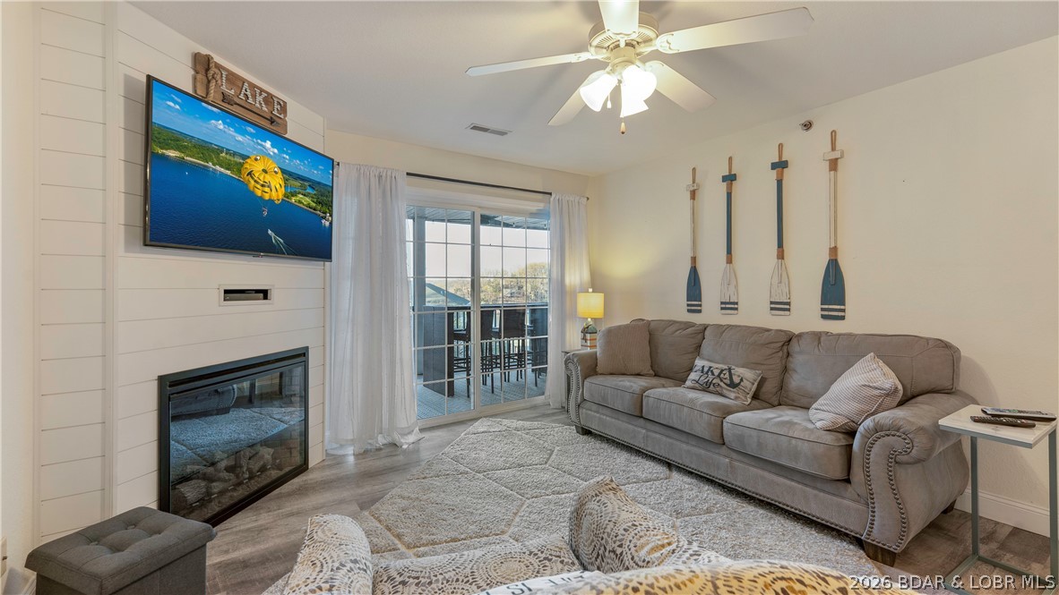 Wake up to peaceful cove views from your screened deck at this beautifully furnished, turn-key end unit in Highland Shores — one of Horseshoe Bend's most sought-after lakefront communities. This 3-bedroom, 3-bath condo offers true single-level living with an open floor plan, luxury vinyl plank flooring, electric fireplace, walk-in closets, and a covered screened deck perfect for gathering or unwinding. Two lakefront suites, a full appliance package, and tasteful décor make this unit immediately ready for personal enjoyment or short-term rental income — nightly rentals permitted. Community amenities include two pools, a designated pet area, and dock access with slips available for lease. Conveniently located at the 14-mile marker off Horseshoe Bend, you're minutes from top dining, entertainment, and water sports. Whether you're searching for a lake retreat or an STR investment, this end unit checks every box.