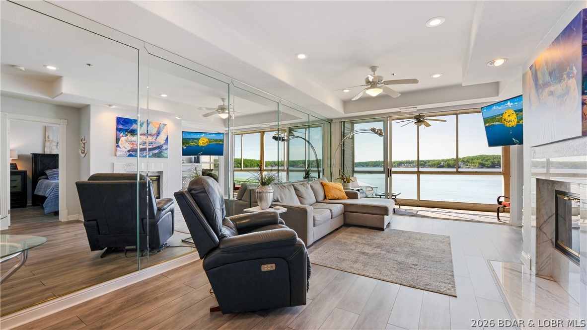 Enjoy stunning, unobstructed waterfront views of the main channel from this walk-in 2 bedroom, 2 bathroom condo, featuring just four steps off the parking lot.  Ideally located on the 14MM central to all the lake’s hotspots and at the beginning of Horseshoe Bend for easy in and out on those busy weekends.  The screened in deck will be your favorite spot as you watch the boat action and hear the relaxing splash of water and see turtles sunning. The 12’ x 32’ boat slip with approximately 12,000 lb. hoist is visible from the condo and with no steps to get to the wave-break protected dock, it’s a breeze rolling your cooler to the boat!  Move-in ready and the kitchen is fully updated with brand new ceiling-height cabinets, solid surface counters, and stainless steel appliances.  Furnished and conveniently located next to one of two pools and the clubhouse with fitness equipment.  Tennis/pickleball/sports court available for a little friendly competition. Perfect for lakefront living with easy access to amenities, recreational activities, golf courses, shopping and some of the lake’s best restaurants and music venues.