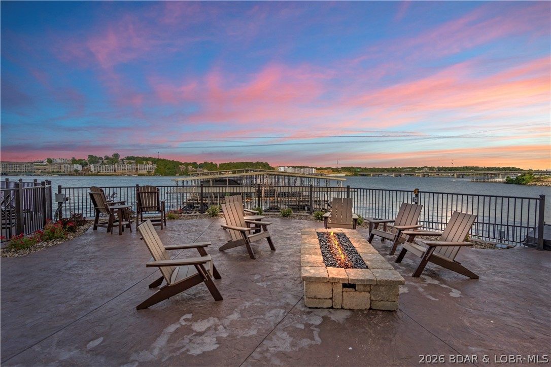Walk-in level lakefront condo at The Hamptons in Osage Beach offering direct, stair-free access and convenient proximity to community amenities. This thoughtfully designed residence features an open-concept layout, abundant natural light, and custom built-in bunk beds to maximize sleeping capacity for guests. The interior showcases a distinctive design palette that sets it apart from typical neutral finishes. Enjoy access to the extensive amenities available within The Hamptons community, including a clubhouse, fitness center, pool, and lakefront recreation areas. Boating enthusiasts will appreciate the exceptional dock options, including 32', 48' and 60' slips, providing space for multiple boats and watercraft. Located in the heart of Osage Beach at Lake of the Ozarks, this property offers convenient access to shopping, dining, golf, marinas, and year-round entertainment. Priced below comparable new-construction opportunities within the newest phase of the development, this condo presents a rare opportunity to own a lakefront property with premium boating accommodations and resort-style amenities. Ideal as a full-time residence, vacation retreat, or investment property.