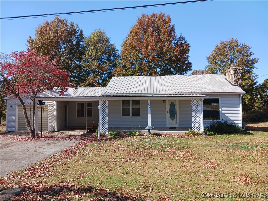 Seller says SELL this remodeled and updated home on a large double-lot in Stover. This home and property represents small-town living at its best, with a combination of luxury vinyl, carpet and newly refinished wood floors. It features new kitchen counters, new appliances and newly installed modern cabinets; and best of all, it is move-in ready for its new owners. It has a full-size basement, newer HVAC and nice metal roof, large outdoor covered deck in back, front porch and patio, and a custom-made fireplace with a cast-iron insert to cozy up to and save heating in winter. This home, with its oak-hardwood floor structure is solid and built to last. Seated on a quiet street in town, it is within walking distance of local schools, restaurants, shops and businesses. It is near the city park, and is only a 20-30 minute drive from the 54,000-acre Lake of the Ozarks. Schedule your showing today and come take a look!
