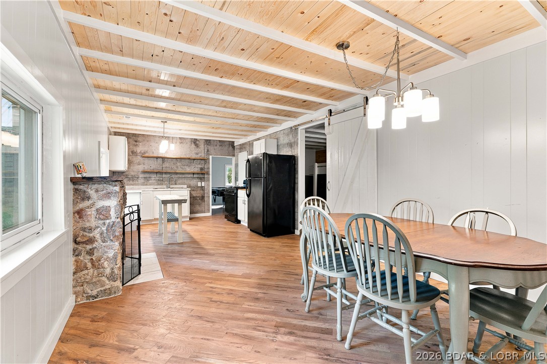 Affordable Lake living with a private dock is hard to find—especially at this price! This beautifully remodeled 2-bedroom, 1-bath home offers the perfect combination of updated comfort, convenience, and Lake of the Ozarks lifestyle for under $275,000. Inside, you'll find a move-in-ready interior with tasteful renovations throughout, while the one-year-old roof provides added peace of mind. Your private boat dock is just a short drive or golf cart ride away, making it easy to spend your days on the water and your evenings back home. Outside, the spacious covered patio/carport is ready to become your favorite place to entertain, grill, or unwind after a day on the water. A large detached outbuilding offers plenty of room for storage, lake toys, or a workshop. By both land and water, the location is tough to beat—just minutes from Fish & Co. and several of the Lake's most popular restaurants, bars, and attractions. Need more room? An additional adjoining parcel is also available for purchase, creating even more possibilities. Whether you're looking for a full-time residence, weekend getaway, or investment property, this is an opportunity you won't want to miss.