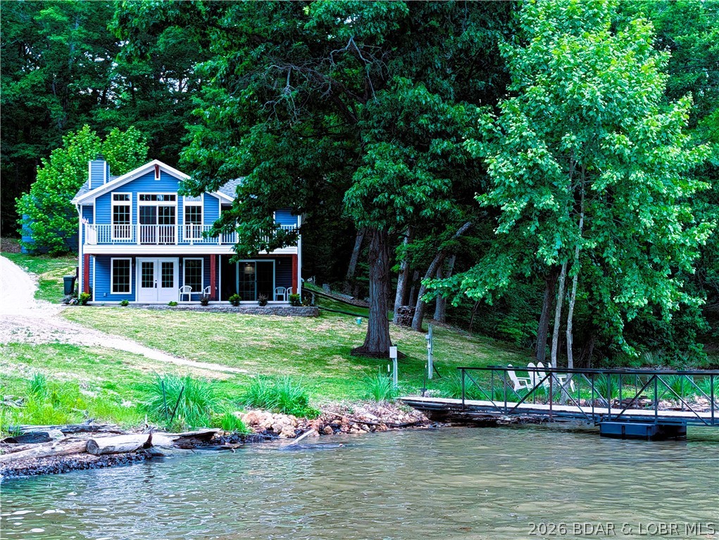 Sandy shores are awaiting you at 123 Summit View Circle on Lake of the Ozarks. Prime location  the 53 MM  Osage  arm 100 ft m/l no steps with gentle water frontage. Custom Rebuilt  in 2026. This 2 story home features beautiful entry from the concrete patio to the living room & wood burning fireplace, spacious floor plan 1810 sq ft features 3 bedroom & 2 1/2 baths.  3rd bedroom nonconventional. Lakeviews from every window  upper level walk out deck from the main bedroom plus a family room on upper level. Coastal modern atmosphere  featuring vaulted ceilings, walk in shower & walk in closets. The open kitchen with quality brand cabinets & extras, brand new SS GE kitchen appliances, barn door to laundry room & pantry right off kitchen. Beautiful  double lot with  main channel views in a protected cove not in a flood zone.  End of the road location  in a nice neighborhood gives you privacy and tranquility. Detached metal garage 20x18 with electric and utility shed 12x8 all this including a easy walk to the  2 well boat dock & 2 boat lifts with 10 ft deep..  Ready for summer fun and move in ready.