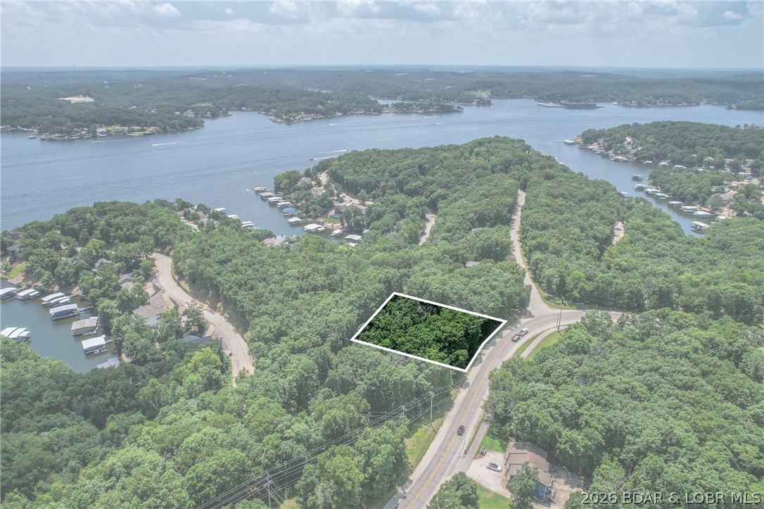 Affordable opportunity in the heart of Four Seasons! This approximately half-acre wooded lot offers a convenient, centrally located setting near shopping, dining, golf, marinas, boat ramps, and other Lake of the Ozarks attractions. Ownership includes access to desirable Four Seasons amenities, making this a great option for a future homesite, long-term investment, or securing your own piece of the Lake lifestyle.