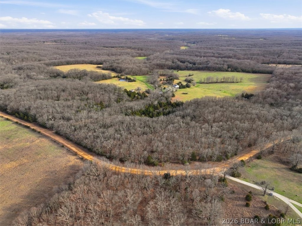 389 acres spanning across three counties and offering a strong combination of productive pasture, mature timber, live water, and excellent recreational appeal! The property includes 5 large open fields along with an additional string of fields that work perfectly for shooting lanes, food plots, or to hay. Multiple creek crossings, 4 year-round ponds, and a natural spring provide consistent water throughout the tract. The terrain lays exceptionally well with flat ground and gentle topography in the pastures, creating numerous quality building sites and easy access across the property by ATV or UTV and a mix of terrain in the timber acreage. Strong deer and turkey presence make this an outstanding hunting tract with food plots maintained in recent years and bedding areas. Over a mile of road frontage between Waisner Ave and Purmiville Dr adds flexibility and access. Well, electric, detached garage/shop, and a fixer-upper home that could serve as a hunting cabin are already in place. Unlimited possibilities for homesteading, hunting paradise, running livestock, or developing!