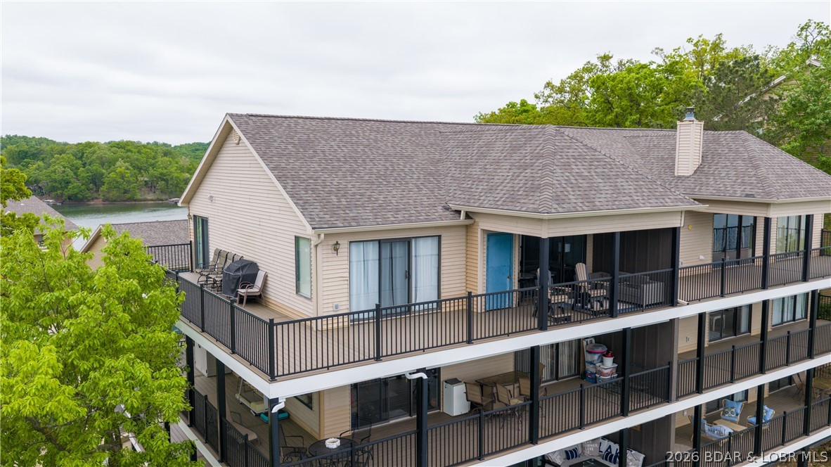 This top-floor 2BR/2BA unit offers privacy, thoughtful upgrades & sweeping lake views—no one above you, just quiet surroundings. Inside, the spacious open floor plan with vaulted ceilings & large windows fills the condo with natural light, creating an inviting, retreat-like feel. The living area is perfect for relaxing or entertaining, featuring a gas fireplace & a convenient wet bar. Both bedrooms enjoy lake views with direct access to the wrap-around deck through sliding glass doors, blending indoor & outdoor living. The deck is a true highlight, upgraded with new vinyl decking, metal posts & powder-coated railings—ideal for enjoying stunning sunrises & sunsets, can easily convert deck area into a screened in porch, giving you the best outdoor options with over 4+ miles of lake views. Access is easy with only one small flight of stairs from the left side of the building. This unit can be turnkey with the furniture available, this condo also includes ample storage, a 10x28 boat slip & two PWC spaces with drive-on lifts. The community offers pools, a playground & tennis/basketball courts for a complete resort-style experience.  The Best Unit in the Falls complex, just come see it!