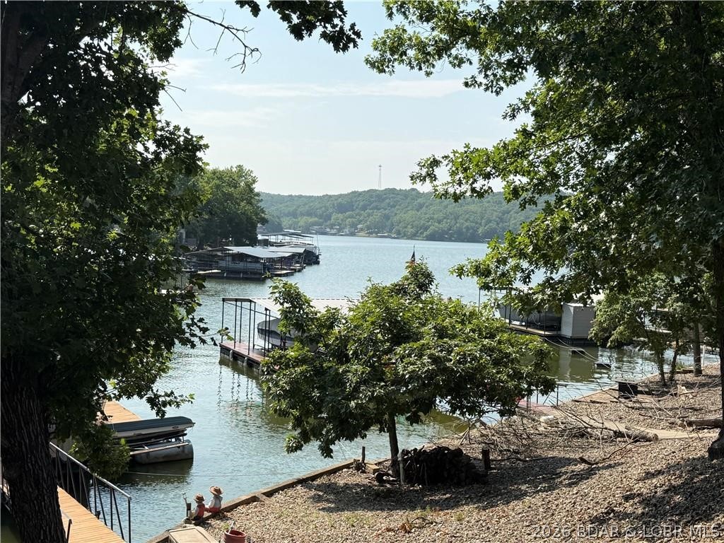Lakefront Paradise on the 6 MM of the Gravois Arm!
Don't miss this incredible 3-story, 4-bedroom, 2-bath lakefront home sitting in a peaceful cove on the 6 MM of the Gravois Arm! Whether you're looking for a full-time residence, vacation getaway, or income-producing investment, this property has it all.
Enjoy breathtaking lake views from three levels of spacious decks, or relax on the martini deck by your private one-well dock while taking in the sunset. The walk-out basement offers additional living space and room to add a fifth bedroom, increasing both flexibility and rental potential.
With ample parking and short-term rentals allowed, this home is ready to welcome family, friends, or vacation guests.
Located just minutes from LOTO and The Loop Off-Road Park, you'll have easy access to waterfront restaurants, shopping, entertainment, and miles of off-road trails. Spend the morning on the water, then switch gears and enjoy an afternoon of ATV or UTV riding—it's the perfect combination of lake life and adventure!
You'll also appreciate the convenience of community water and sewer, eliminating the maintenance of a well and septic system.
Schedule your private showing today!