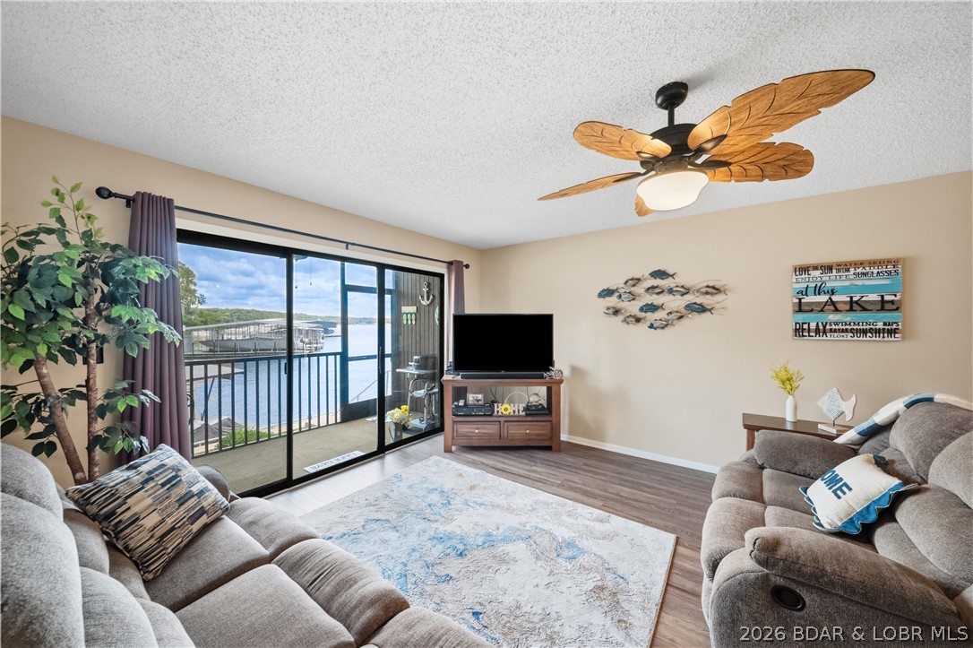 Fresh & inviting 2BR/2BA waterfront condominium at the 21MM! Perfectly positioned at the water's edge, you'll enjoy the convenience of having your boat and PWC just a short walk from your door. This desirable end-unit offers added privacy, and a peaceful setting. Located in a protected cove w/ beautiful main channel view, you'll enjoy the best of both worlds. Inside you will find an updated kitchen, newer flooring, fresh paint & remodeled bathrooms. The tasteful, neutral furnishings make this condo completely move in ready & is being sold turnkey. The package includes a boat slip with lift & a PWC sill with lift. Even better the Crownline boat and Yamaha Waverunner are available for purchase making it easy to start enjoying lake life immediately. Harbor Point allows nightly rentals, & its central location by both land & water makes it highly desirable for owners & guests alike. Popular waterfront destinations including Redhead Lakeside Grill, Shorty Pants, Dog Days, & Margaritaville are all minutes away by boat or car.  The location. The views. The updates. The boat slip. The rental potential. The opportunity. Schedule your showing before someone else is living your lifestyle.