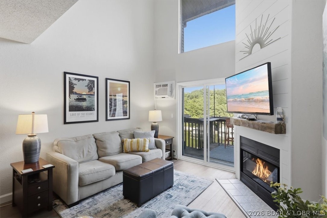 Completely remodeled and turn-key, this 3-bedroom, 2-bath condo offers 1,400 sq. ft. of updated living space in a small, well-maintained complex with only 12 units. Features a redesigned open-concept floor plan with new kitchen cabinets, quartz countertops, tile backsplash, stainless steel appliances, added dishwasher, and center island with bar seating. Luxury vinyl plank flooring, new carpet, shiplap fireplace wall with reclaimed wood mantel, and updated lighting complete the modern lake-style feel. The spacious loft provides bonus living space or additional sleeping area, while the utility room and extra storage room offer plenty of storage. Additional updates include new windows with lifetime warranty, remodeled bath, remote-control electric fireplace, updated electrical panel, switches, outlets, doors, and wall-mounted A/C units. Enjoy a 10x28 boat slip in a year-round deep-water, no-wake cove including a 10,000lb hoist. Low association dues!! Conveniently located near restaurants, shopping, and entertainment, this unit is ideal as a full-time residence, vacation getaway, or rental investment.