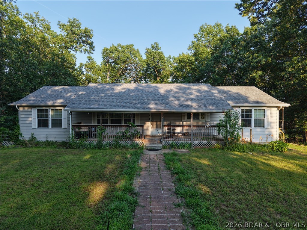 Tucked away at the end of an almost ¼-mile private driveway, this move-in ready property offers privacy, recreation, and endless potential just minutes from the lake. Situated on 97 wooded acres with abundant wildlife, it's the perfect blend of country living and outdoor adventure. The manufactured home features 3 bedrooms, 3 full bathrooms, and 2 non-conforming rooms, offering flexible space for guests, an office, or hobbies. The open-concept layout includes a spacious living room with a cozy wood-burning stove, a bright eat-in kitchen, main-level laundry, and a generous primary suite with a private bath, ample closet space, and deck access.
The partially finished walk-out basement offers a second living area with a bar, a full bathroom, and additional rooms ready to finish to fit your needs. Outside, you'll find an oversized 2-car attached garage and a 30x40 pull-through shop with concrete floors and electricity—perfect for equipment, projects, or lake toys. With acreage, privacy, and lake access just minutes away, this property is ready for your next adventure. Schedule your private showing today!