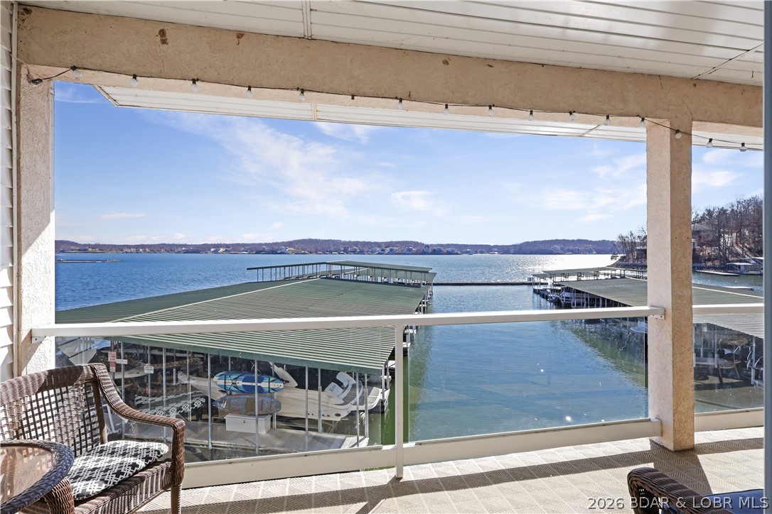 Experience the best of Lake of the Ozarks living in this beautifully updated 2-bdrm, 2-bth condo at Emerald Bay! Featuring stunning main channel views, this move-in-ready property comes fully furnished & includes a 10x24 boat slip w/ 4000# hoist, making it ready for immediate enjoyment. The open-concept floor plan offers comfortable living & entertaining space, while the lakeside deck provides the perfect setting for morning coffee, outdoor dining or relaxing while taking in the breathtaking lake views. Conveniently located by both land & water, you'll be just minutes from popular waterfront restaurants, golf courses, shopping & entertainment.  Emerald Bay is a highly desirable community featuring a lakeside pool, beautifully maintained grounds & affordable HOA dues. Established nightly rentals within the complex make this an excellent investment opportunity, vacation getaway, or full-time residence. Whether you're boating, golfing, dining, or simply enjoying the lake lifestyle, this condo offers the ideal combination of location, convenience & value. Don't miss your opportunity to own a lakefront property in one of the area's most sought-after communities!