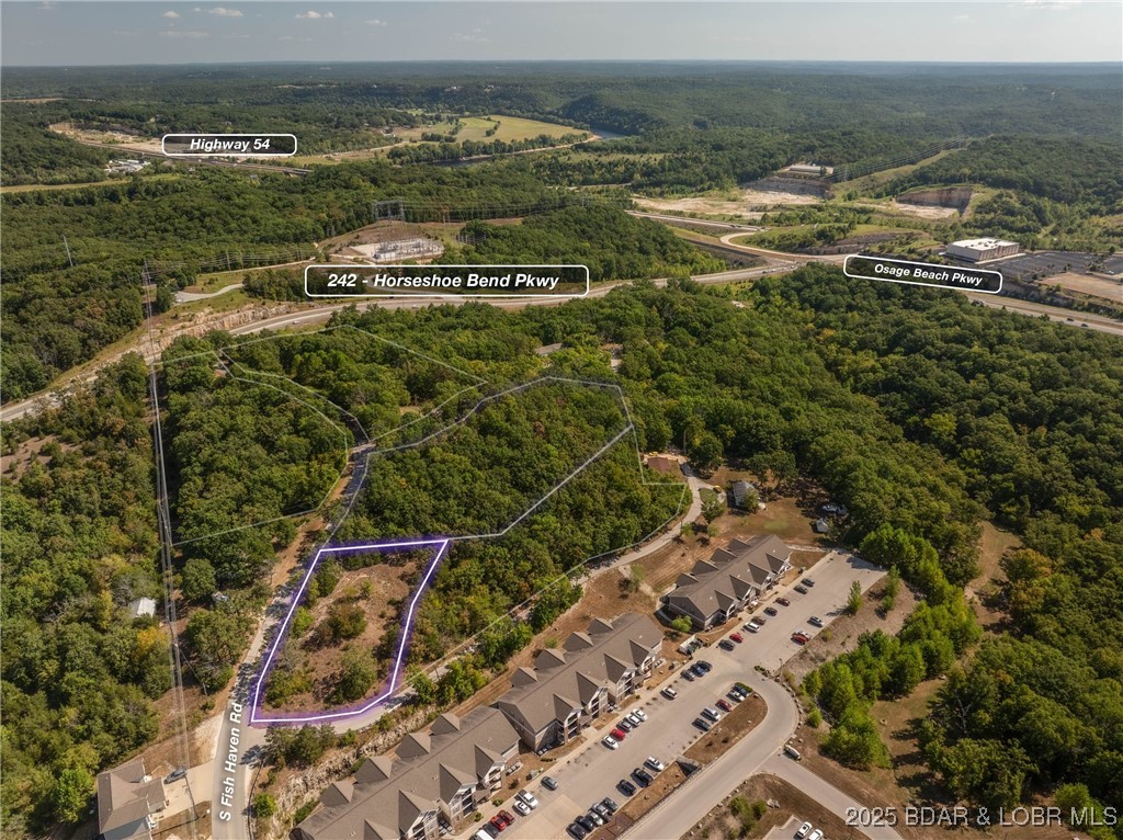 Gentle lot ready for development and construction with a spectacular Lake Ozark Location.  Road frontage with easy access from the city maintained Fish Haven Rd.  This is two lots that would make a great homesite or there is the possibility of a multifamily situation.  Of course everything would have to be city approved but the adjacent lot which is also listed was zoned high density residential and this is in a future development area of Lake Ozark.  City and city sewer as well as electricity are available.  Looking for more land, be sure to ask your agent, the seller has several parcels in this area!