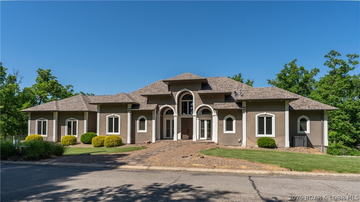 Experience elevated golf course living in the prestigious Old Kinderhook community at Lake of the Ozarks. Set on a double lot with panoramic, unobstructed views of Hole #3 from tee box to green, this one-owner residence offers an exceptional blend of space, comfort, and entertainment. Featuring 5 bedrooms, main-level living, expansive gathering areas, and a remarkable private retreat beneath the 3-car garage with its own HVAC, full bath, and bar, this home was designed to impress. The open kitchen, dining, and living spaces offer generous cabinetry and seamless flow for hosting on any scale. The lower level is an entertainer’s dream with a wet bar, full-size refrigerator, dishwasher, microwave, and an oversized lounge area perfect for sports or movie nights. Outside, enjoy a sunken hot tub overlooking the fairway and 4 separate deck areas that take full advantage of the setting. This is a rare opportunity to own a distinctive home in one of the Lake’s most sought-after gated golf communities.