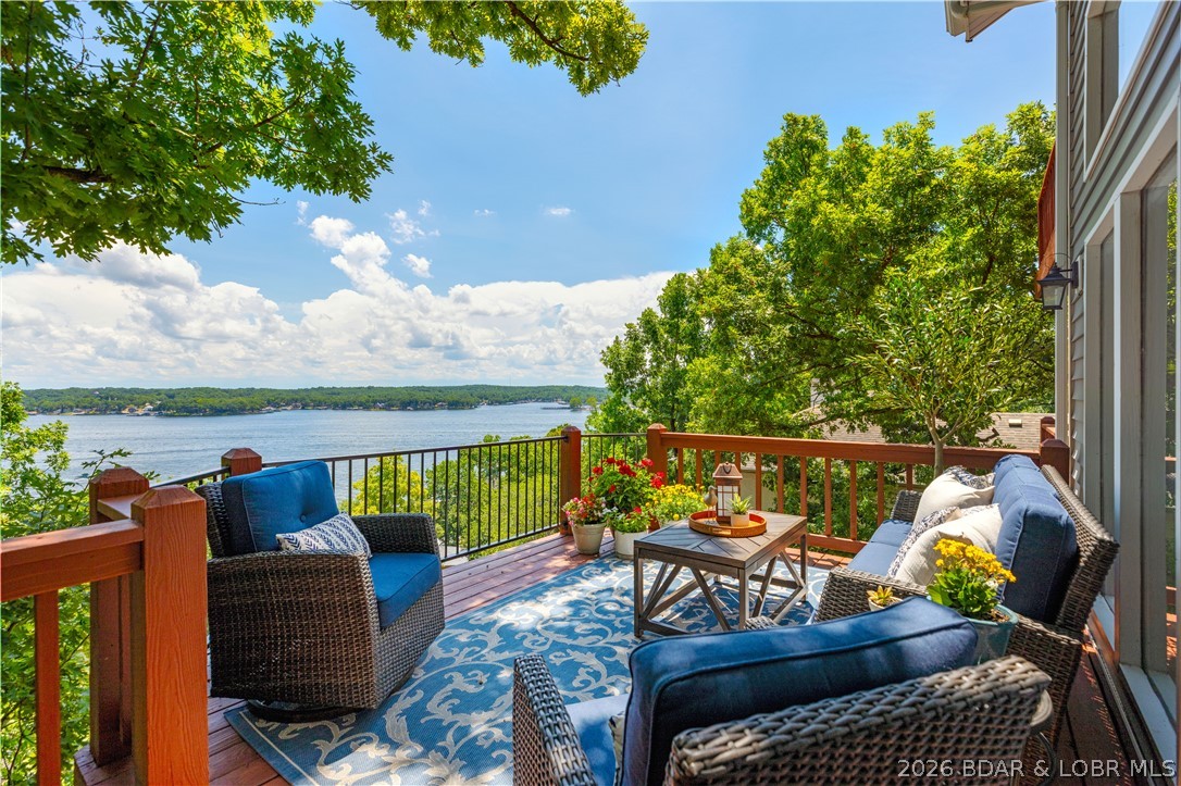 Some homes are built for living, some for entertaining—the best are built for both. This magnificent home spans three spacious levels and captures breathtaking main channel views. This home was made for comfortable main-level living, the primary suite, laundry, kitchen, dining, and living room are all conveniently located on the main floor. Soaring vaulted ceilings and expansive windows  fill the home with natural light, the windows also feature custom electric shades, while the updated kitchen features granite countertops, a pantry, and an open flow into the main living area. Step onto the lakeside deck to enjoy the view or retreat to the primary suite with a walk-in closet, spa-like bath, cozy stone fireplace, and private balcony overlooking the water. Upstairs are two additional bedrooms and a full bath, while the walkout lower level offers a spacious family room, fourth bedroom with it's own bath, and abundant storage. Three levels of decks provide plenty of space to relax and take in the lake views. Located in the highly sought-after Four Seasons community with access to indoor and outdoor pools, tennis and pickleball courts, fitness center, clubhouse, boat ramps and more.