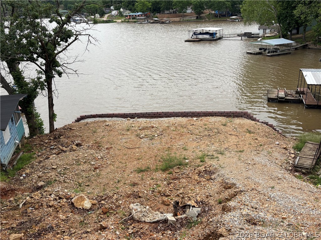 Build your dream lakefront getaway on this ready-to-go lot in a protected cove with stunning main channel views. The property features a brand-new retaining wall, and the previous cabin has already been removed, giving you a clean slate to design exactly what you want. Utilities are already in place, saving you time and expense as you plan your build. Enjoy calmer waters ideal for swimming and boating, along with the convenience of a neighborhood boat ramp nearby. Additional perks include extra blocks for a second retaining wall and pre-dug ground across the road for expanded parking. This is a rare opportunity to own a well-prepared lakefront property in a prime location.