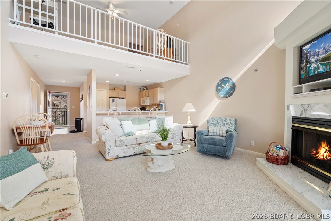 Enjoy peaceful lake living at the 5 MM of the Big Niangua Arm in a No Wake cove.  This spacious 1500 sq ft well-maintained 3 BR, 3 bath condo located in a smaller complex at the Lake of the Ozarks. with no rentals allowed, offers a quiet and relaxing atmosphere. The two-level floor plan features an open living area and comfortable space for family and guests. The upper-level loft serves as the third bedroom with a full bath, providing great additional sleeping space and privacy. Room for family and friends. Step out onto the screened porch to enjoy the calm cove setting, perfect for morning coffee or relaxing after a day on the water. This condo is being sold fully furnished, making it move-in ready and ideal for a weekend getaway or full-time lake living. Boaters will appreciate the 12x30 boat slip with hoist included, offering easy access to the lake. 24 ft Tritoon G3 Suncatcher with 225 hp Yamaha outboard for sale also.  The complex also features a community pool and well-kept grounds. A great opportunity to own a turn-key lake retreat in one of the quieter areas of the lake while still close to popular waterfront destinations. Dreams to Reality.  Call Today!