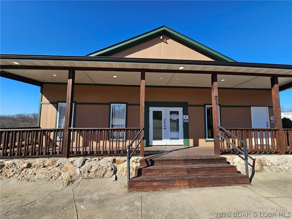 MOTIVATED SELLER/OWNER FINANCING with 20% down and 5% interest! If you're exploring commercial opportunities at the Lake of the Ozarks, this is one you won’t want to miss. This prime highway frontage property offers exceptional visibility and steady high-traffic exposure in the heart of the lake area.  Previously operated as a bar and grill, this turnkey property is ready for your next venture—whether that’s a restaurant, bar, entertainment venue, retail space, or something entirely new. The flexible layout makes it easy to bring your vision to life.  Positioned to capture both local and tourist traffic, this location provides built-in exposure and strong potential for success. Two on-site 2 bed 1 bath apartments, perfect for generating rental income or providing owner/employee housing. One is setup for Airbnb and part of this package. Located less than 10 min. from Bagnell Dam and just 15 min. to Osage Beach you’ll be right in the center of it all. The 1.92-acre lot offers additional space for expansion or future development. Whether you're launching a new business or expanding your portfolio, this is an affordable opportunity to establish yourself at the Lake of the Ozarks.