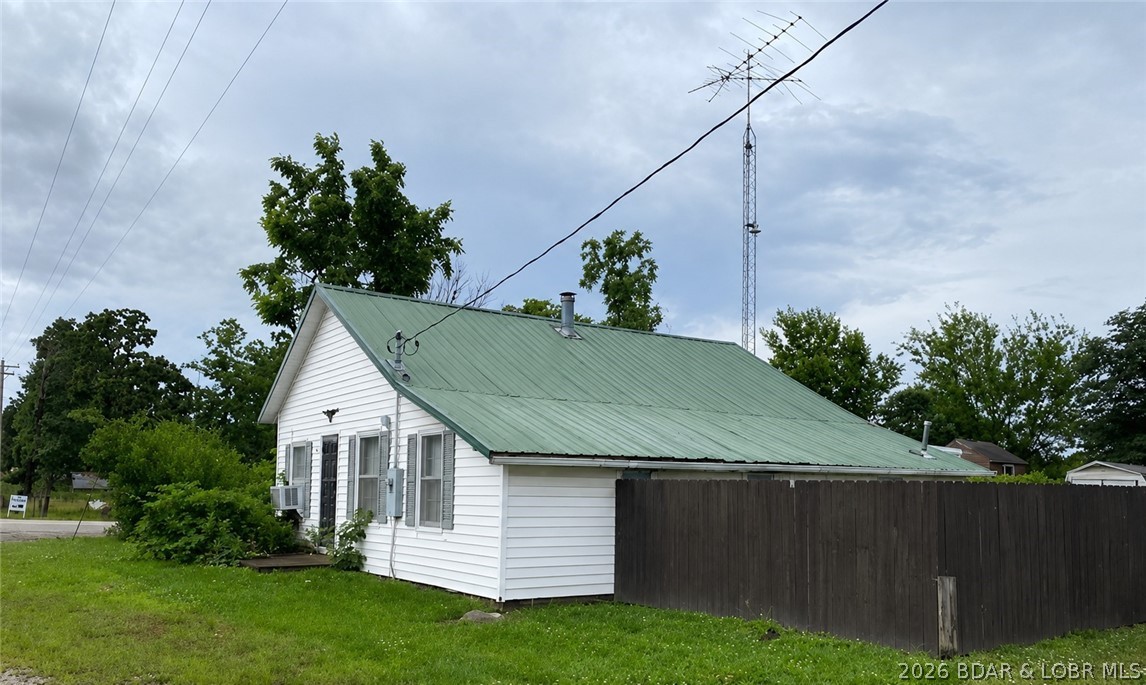 Main floor living home w/ quick access to highway routes into larger cities- Lake of the Ozarks, Buffalo, Preston, Springfield, MO; 1024 sf interior w/ 2 bedroom  & 1 bath, large kitchen connecting to comfortable multi use living room, a versatile enclosed porch, storage shed and an awesome 30x50x16 shop for that collector car, RV or hobby.  This home provides a large kitchen w/ lots of counter space for the gourmet chef & eat in dining area. The 2 bedrooms are located at opposite spaces in the home, providing privacy for occupants. A single step down & your shared bath is convenient to the center of the home.  The laundry area is bright & offers additional storage space.  The shop is currently used for RV storage & the car enthusiast & a place to hang out and entertain. A manageable home set up is ready for its next occupant to make their new memories!  NOTE:  This property will to GO TO AUCTION on Tuesday, August 25, 2026; home is being sold AS IS WHERE IS, w/ No Warranties; List price is not reflective of the final selling price. Shown by appointment.