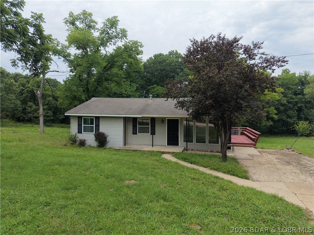Enjoy peaceful country living with convenient Lake of the Ozarks access just one mile away! For only $35 per year, you can use the nearby neighborhood boat launch and spend more time on the water. Renovated in 2026, this 3-bedroom, 1-bath home offers 1,009 square feet on a level, mostly open .78-acre triple lot with room to enjoy the outdoors. The open-concept layout features an updated kitchen with new cabinets, countertops, and appliances, along with new LVP flooring throughout. A deck off the dining area and backyard fire pit create inviting spaces to relax and enjoy the quiet country setting. With no HOA and short-term rentals allowed, this is an appealing starter home, weekend lake getaway, or vacation-rental opportunity. Property is being sold as-is.