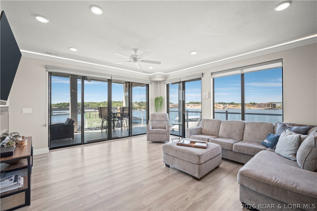 WALK IN LEVEL - END UNIT - Indulge in effortless luxury in this stunning, fully furnished lakefront condo where every detail exudes elegance & every amenity is at your fingertips. This lovely unit is perfect for families, entertaining or investing. This turnkey gem includes a 12 X 36 boat slip & boat lift, dock locker & STUNNING Views. Gorgeous LVP & Tile flooring throughout, a chef's kitchen w/ quartz countertops & black SS appliances, exquisitely tiled showers, a generous living room area anchored by a lovely fireplace & bathed in natural light, as well as beautiful furnishings & decor make this unit ready to enjoy TODAY! The tiled, expansive wraparound deck is family friendly & waiting for you to hit the grill, catch up & watch glorious sunsets. Upon project completion, amenities will include 2 Million Dollar+ lakefront swimming pools, 2 dog parks, 2 EV charging stations, a clubhouse, lakeside fire pits & pickleball courts. Located in the heart of Osage Beach - across from Oasis @ Lakeport & minutes from the soon to come Bass Pro Project, this unit will only continue to appreciate in value - don't miss your chance to make this breathtaking unit your Lake of the Ozarks legacy!