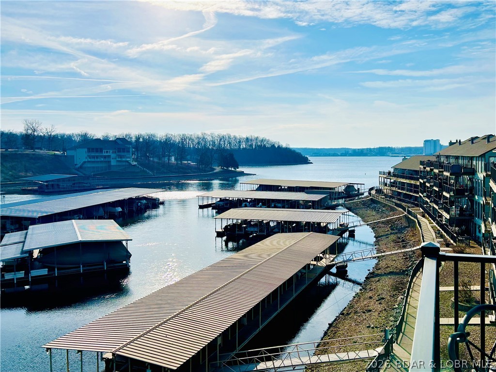 Step into easy lake living with a completely turn-key 2 bed, 2 bath lakefront condo that will have you ready to say, “Let’s write an offer!” Perfect as a relaxing weekend escape or income-producing rental, this unit checks every box. Included 10x24 boat slip w/6,500 lb lift plus PWC lift — both conveniently located right in front of your private deck for effortless access to the water.
Start your mornings w/beautiful sunrise views over the lake & unwind in the evenings w/cool, shaded comfort. Condo entrance is easily accessible from the lighted boardwalk, adding both charm & convenience. Located in the highly sought-after Horseshoe Bend area, you're minutes from popular waterfront & roadside dining destinations. Recent updates include new flooring, a newer water heater, upgraded electrical to the dock, and more — all complementing the stunning lake views. Southwood Shores offers fantastic amenities such as indoor and outdoor pools, a hot tub, swim dock, concrete boat ramp, gated access, tennis courts, and a clubhouse. Looking to complete the full lake lifestyle? Schedule your private showing today!