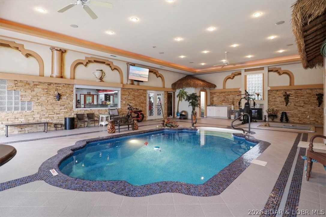 THE ULTIMATE LIFESTYLE STATEMENT. Welcome to a masterclass in luxury where mid century nostalgia meets
cutting edge sophistication. Positioned perfectly off Highway 54 between Lake Ozark and Jefferson City, this
estate redefines having it all and would make an incredible investment as a high end AirBnb. This sprawling
residence features 4 bedrooms, 5 baths, and 2 full kitchens sitting on 4 acres. Step into your private 1950s
diner with its own full kitchen, jukebox, and black and white tile. Host legendary evenings at the shuffleboard
table or retreat to the Indoor Aquatic Center featuring a heated pool, hot tub, sauna, and fireplace. This year
round oasis is the pinnacle of luxury. Primary suite includes a bidet, jet tub, and custom walk in shower.
Security and tech are paramount with a 15x15 concrete safe room, full camera surveillance, smart Govee
lighting, and built in sound. Features include 3 car and 1 car split garages, EV charging, and 3 sets of laundry
hookups. From the custom copper dining ceiling to Sub Zero refrigeration, no expense was spared. Fully fenced
with concrete all the way to the front door. Own it. Broker owned.