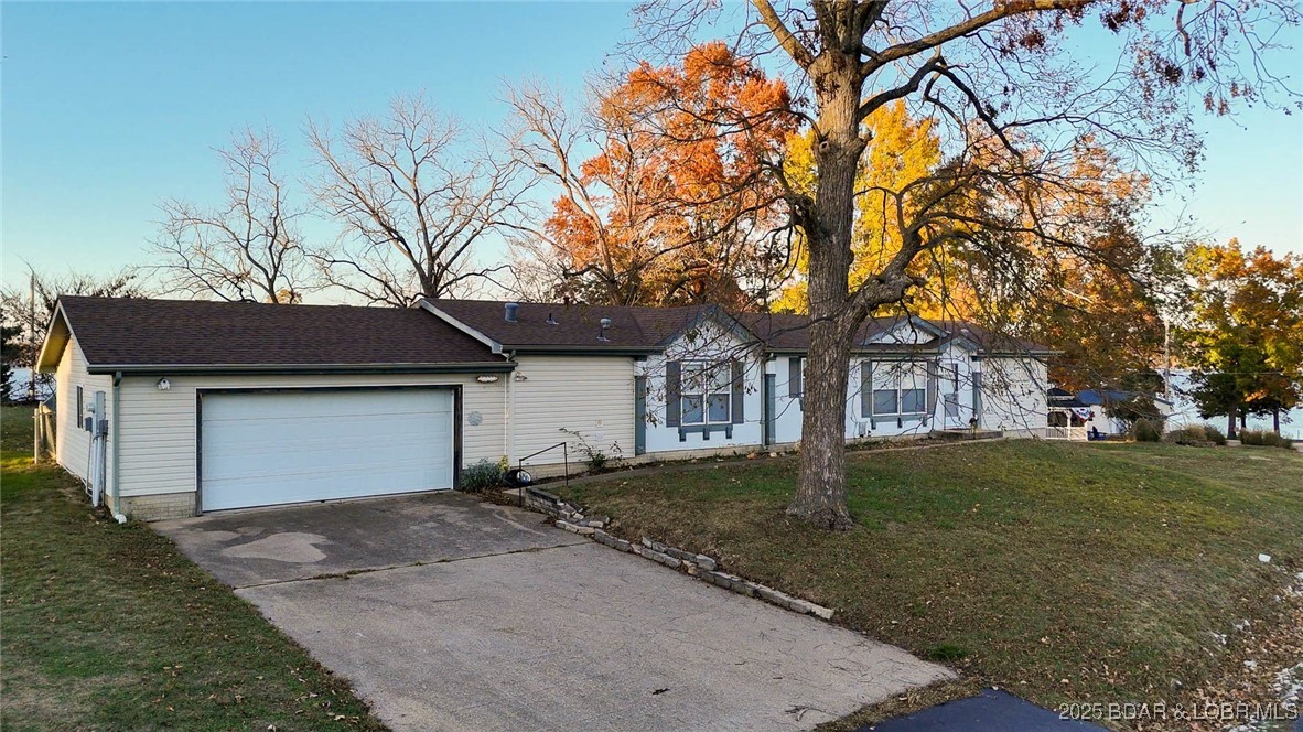 Have you been looking for a FLAT lot, beautiful lake views, great lake access, that won’t break the bank? Then stop what you’re doing now and come see this home! Featuring 270-degree views, single level ranch floorplan, gated entrance to the subdivision, and city utilities, this home is as low maintenance as they come!! With a new roof, this home is ready for you to put your finishing touches on it! Located at the mouth of the Gravois arm, this home is close to EVERYTHING!! From the home, you are minutes away from Tap and Grill, Millstone RV Park & Marina, and just a short boat ride from Jolly Rogers, Alhonna, Camden on the Lake, and Coconuts. Enjoy your days watching the boats go by or throw the boat in the water and enjoy the fun! With ease of living at the forefront of the experience with this property, it is not one you are going to want to miss! Jump on it before it’s gone!