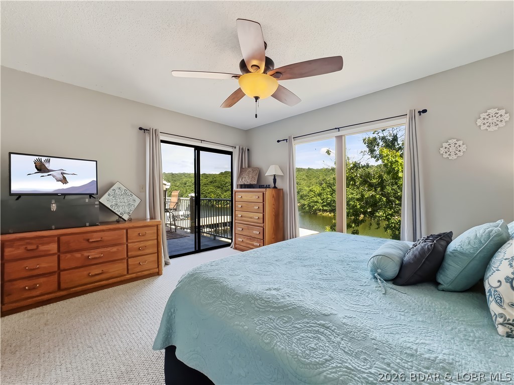 LAZY DAYS – TOP-FLOOR END UNIT LAKEFRONT CONDO! Welcome to an easy Lake of the Ozarks escape in the heart of Osage Beach. This updated 2-bed, 2-bath end unit offers beautiful lake and untouched State Park views from the private deck - the perfect spot for morning coffee or sunset cocktails. Inside, the condo is being sold turnkey with comfortable furnishings, updated appliances, wood floors, refreshed fixtures, and new outdoor furniture, so you can start enjoying it right away. Included is a 10x24 boat slip in Dock B with a 5,500 lb heavy duty hoist, dock locker, and dock steps—ideal for boating, swimming, kayaking, paddleboarding, or spending the day tucked into calm cove water. Lazy Days is a long-time favorite Lakefront condo complex with two pools (one right across from the unit!), clubhouse, BBQ pavilion, playgrounds, dog park, boat ramp, lakeside boardwalk, trailer parking option, and a location close to dining, shopping, golf, marinas, and Osage Beach attractions. With nightly rentals allowed and rental history already in place, Unit B12 works beautifully as a personal retreat, weekend getaway, or income-producing investment at Lake of the Ozarks.