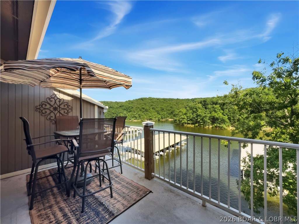 LAZY DAYS – TOP FLOOR LAKEFRONT CONDO! Welcome to an easy Lake of the Ozarks escape in the heart of Osage Beach. This updated 2-bedroom, 2-bath end unit offers beautiful lake and State Park views from the private deck, giving you the perfect spot for morning coffee, sunset cocktails, or simply watching the lake do what the lake does best. Inside, the condo is being sold turnkey with comfortable furnishings, updated appliances, wood floors, refreshed fixtures, and new outdoor furniture, so you can start enjoying it right away. Included is a 10x24 boat slip in Dock B with a 5,500 lb heavy duty hoist, dock locker, and dock steps—ideal for boating, swimming, kayaking, paddleboarding, or spending the day tucked into calm cove water. Lazy Days is a long-time favorite Lakefront condo complex with two pools, clubhouse, BBQ pavilion, playgrounds, dog park, boat ramp, lakeside boardwalk, trailer parking option, and a location close to dining, shopping, golf, marinas, and Osage Beach attractions. With nightly rentals allowed and rental history already in place, Unit B12 works beautifully as a personal retreat, weekend getaway, or income-producing investment at Lake of the Ozarks.