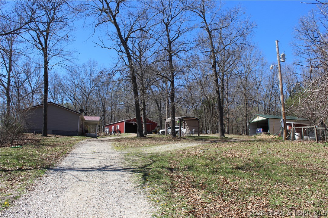 Vacation Where You Live – 75+ Acres with Live Water Creek in Central Missouri

Escape to your own private retreat where every day feels like a getaway. This exceptional 75+ acre property offers a rare blend of recreation, functionality, and homestead living, complete with a year-round live water creek.

The land features a mix of open ground and timber with established trails for hunting, riding, and exploring. Abundant wildlife and usable acreage provide opportunities for livestock, crops, or expansion.

The home offers an open-concept layout with a recently updated kitchen, modern appliances, granite countertops, inside laundry, and easy patio access. A wrap-around porch and outdoor spaces enhance relaxed country living.

Improvements include a 200-amp service to home and shop, large shop with utility room, detached garage, smokehouse, canning shed, and a cozy cabin. Ready for a working homestead with pig pen, calf shed, and chicken run with water and power.

Located near Lake of the Ozarks for boating, fishing, and recreation. Privacy meets convenience—ideal for a hunting retreat, farm, or full-time living.