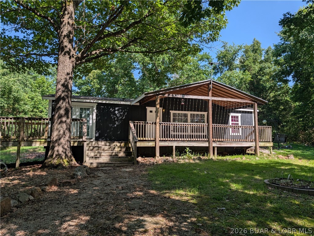Imagine 11 acres +/-  surrounding a nicely updated 3 bedroom 2 bath one level living home. Lots of upgrades and remodeling gives the manufactured home  move in ready for a new homeowner. Spacious covered and open deck spans the front of to enjoy the tranquility & privacy . Front and back yard is open and flat around home  for any outdoor activities. Floorplan offers living room  that splits  2 bedrooms and full bath from  the primary bedroom & full bath. Beautiful kitchen  features granite counters, nice cabinetry and the  bar . Dining room area  continues to laundry room with cabinets.    The interior walls have  sheet rock  including nice tilt windows makes for easy cleaning also no carpet all flooring is plank in. Fresh paint inside and out. Private well and septic.