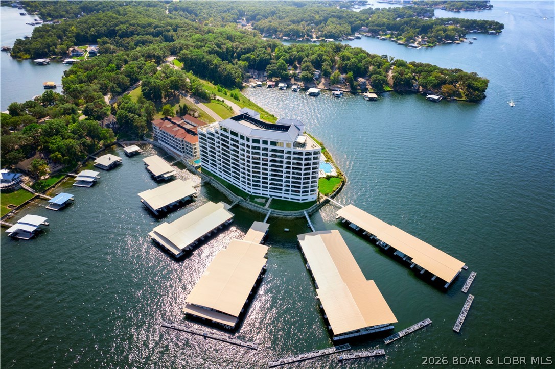 166 Captiva Dr #3C in Sunrise Beach is where luxury lake living slows down and opens wide. Set at Cypress at the Lake, this 4 en-suite, 4.5 bath condo was designed to make the view part of everyday life. The main channel stretches out from the spacious covered tiled deck, with two en-suites and multiple living areas opening directly outside. Start the morning with coffee on the deck, gather around the fireplace, or host with ease from the wet bar just steps from the lake breeze. The primary retreat offers a jetted tub and walk-in shower, while one-level living, furnished interiors, elevator access, garage and open parking, a 12x32 slip, pool, clubhouse, fitness area, dog park, and gated entry complete the lifestyle.