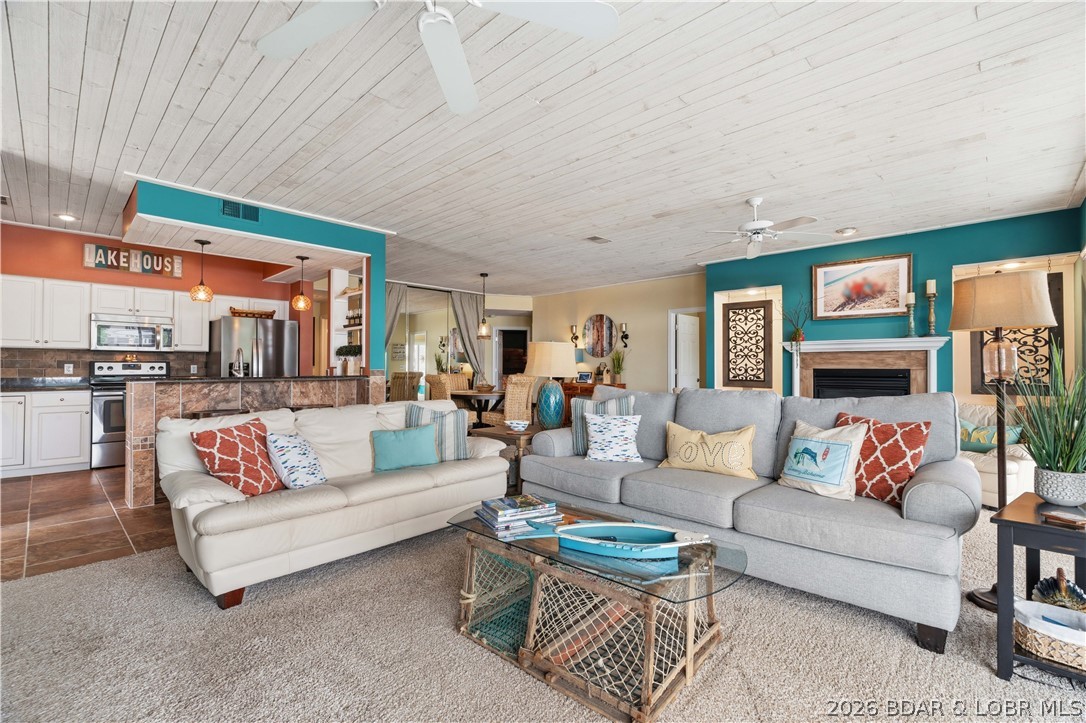 Enjoy the lake lifestyle you've been dreaming of at The Evergreens on the Lake. This beautifully remodeled 3-bedroom, 3-bath condo offers the perfect combination of comfort, style, and convenience in a sought-after lakeside setting.  Designed to maximize the stunning water views, the open-concept floor plan features stylish shiplap accents, a spacious living area with a cozy gas fireplace, and large windows that bring the lakefront scenery indoors.  Step outside to the oversized screened-in deck, where you can enjoy morning coffee, evening cocktails, or simply relax while taking in the panoramic lake views.  The primary suite is a private retreat featuring direct deck access, a walk-in closet, a jetted tub, and a walk-in shower. Two additional bedrooms and bathrooms provide plenty of space for guests and extended family.  Just a short stroll away, your 12x28 boat slip makes getting out on the water quick and effortless. Located within a well-maintained complex, this property offers a peaceful atmosphere while remaining close to all the shopping, dining, and entertainment.  This lakefront condo is ready for you to start making memories. Schedule your private showing today.