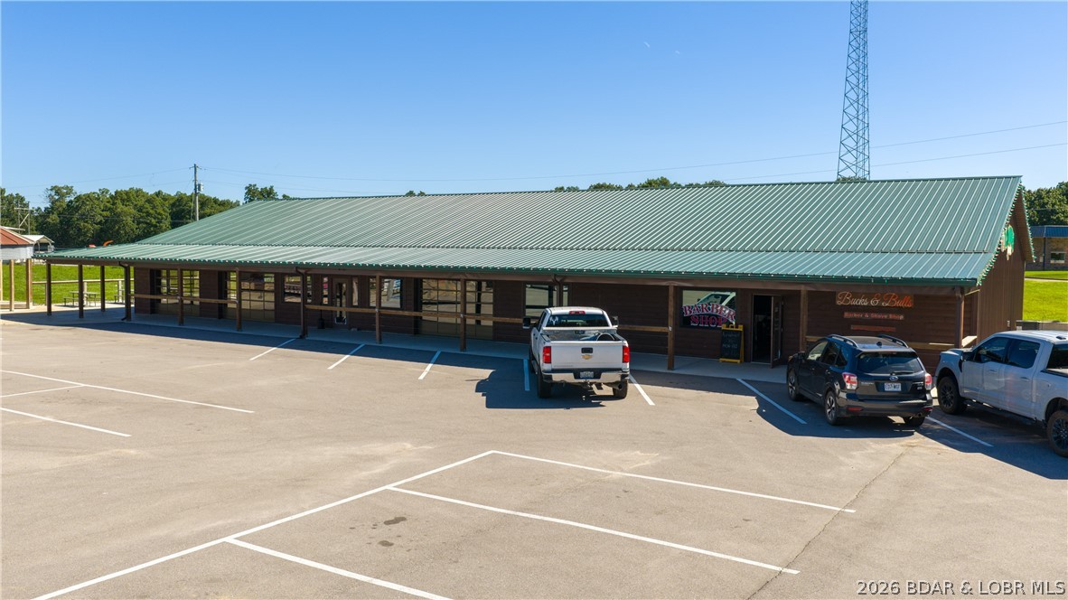 Outstanding commercial opportunity or the ultimate man cave! Completed in 2024, this building offers exceptional flexibility & endless possibilities for investors, entrepreneurs, & business owners alike. Designed w/entertaining in mind as an event center, the event space features a spacious bar area, walk-in cooler, stage & ample room to host weddings, live music, private parties, corporate gatherings & community events. The building is thoughtfully configured w/a separate section that offers additional income-producing potential, making it ideal for retail, office, recreation, specialty services or other commercial ventures. Previously utilized as a 3-D archery venue, the space can easily adapt to a variety of business concepts. Outside, guests will appreciate the generous outdoor gathering areas, while the newly asphalted parking lot provides ample parking & easy access. Whether you're looking to establish a premier event destination, create multiple revenue streams or launch your next business venture, this property is ready to deliver. For an even larger investment opportunity, the turnkey restaurant & pub next door is also available for purchase. See MLS 3588239 for more info.