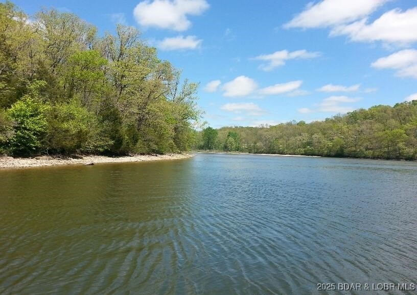 A rare find offering 2,089 feet of gentle shoreline & 17.73 acres of beautiful Lake of the Ozarks land. This exceptional property features a mix of open pasture, valley, hay fields, mature trees, and a spring-fed creek, creating a peaceful and private setting. Abundant wildlife including deer, turkey, and ducks make this an ideal retreat for nature lovers and outdoor enthusiasts. Enjoy fishing, kayaking, and wide-open space to roam. Family owned since 1952, this property presents a once-in-a-generation opportunity to own a large tract of land with extensive shoreline and endless possibilities. Must provide proof of funds and a scheduled appointment only. Sellers agent, owner to accompany all showing (camera/videos on property). Property is occupied and hunted! Trustee for the trust is a licensed real estate agent. DO NOT try to enter property off of Heather rd. and private driveway.
