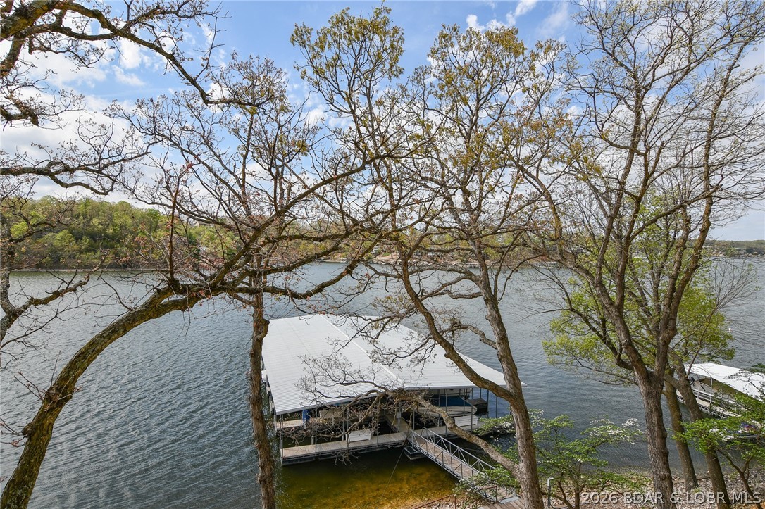 Welcome to your perfect summer escape! This super cute 2-bedroom, 2-bath fully furnished condo includes a 10’x24’ boat slip with hoist—everything you need to start enjoying lake life immediately. Located in the peaceful, quaint community of Jonathan’s Landing on Horseshoe Bend, this lakefront retreat offers comfortable, easy living. The open floor plan features a spacious living area, dining area with convenient bar, and lakeside deck with a beautiful lake view— ideal for morning coffee or unwinding with your favorite evening drink while soaking in the views. Enjoy fantastic amenities including a clubhouse, outdoor pool, hot tub, and sun deck/martini deck for those long summer days. With no nightly rentals allowed, you’ll appreciate the quieter, more relaxed atmosphere. Boating is a breeze with easy access to the community docks—then cruise over to many popular waterfront spots. By land, you’re just minutes from the Bagnell Dam Strip, plus shopping, dining, and entertainment in Lake Ozark and Osage Beach. Nearby state parks offer even more ways to enjoy the outdoors. Whether you’re looking for a weekend retreat or a low-maintenance lake getaway, this condo checks all the boxes.