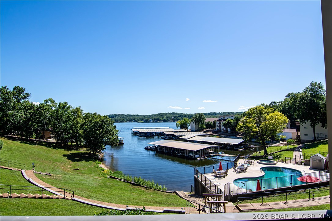 PERFECT LAKE PACKAGE!!! Turn Key Condo that includes 10x24 boat slip, 2 PWCs, remote lift, and dock box for
storage. Start enjoying the Lake on DAY ONE! This beautifully updated 2 bed, 2 bath condo comes fully
furnished and move-in ready—just bring your flip flops. Enjoy breathtaking views from your spacious lakefront
deck, perfect for entertaining or relaxing with a drink in hand. Walk out directly to the heated saltwater pool
from your deck—an unbeatable feature! The fully stocked kitchen boasts updated cabinets and laminate wood
flooring. Recent upgrades include a new range, refrigerator installed in 2018, HVAC installed in 2019, and a
full-size washer & dryer installed in 2024. The complex offers resort-style amenities: 2 sparkling pools, 2 hot
tubs, and a lighted boardwalk for evening strolls. Close to restaurants, marinas, and local entertainment.
Whether you're looking for a serene getaway, full-time home, or income-producing rental, this gem checks all
the boxes!