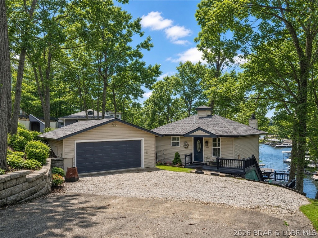 PRICE REDUCTION Motivated Seller! Excellently maintained 1144 sq ft house, Newer roof & HVAC New Hot Water. HUGE oversized garage central to everything! No boat dock, but slip available 5 min from house. Immaculate bungalow in the heart of the lake! Double lot provides both wooded area and lake views with privacy in quiet well maintained neighborhood, yet located near all of the conveniences and fun at the lake. 23x22' master bed w/ lake views. Move into the LL & out on the deck for your morning coffee on your expansive deck.  Newly remodeled main bathroom w/ jetted tub. Heated bidet seat.  Smart home features include thermostat & coded door locks to operate remotely. This home is on first tier. Oversized double garage fits a truck, storage & workbench. New 50 gal hot water tank. Wood burning fireplace…firewood included! Seer 21 Trane HVAC only 5 years old. Washer & Dryer & Garage Fridge Included.