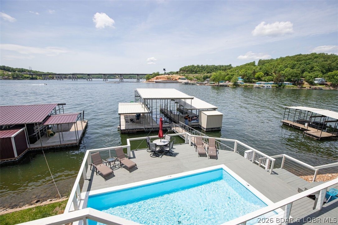 Lake Life Starts Here: A Waterfront Retreat Built for Fun, Friends, an Income!
Welcome to the kind of lake home everyone dreams about—the one where the dock is always the gathering place; the fridge is always full, and the sunset never disappoints. Perfectly positioned on 80 feet of prime lake frontage, this incredible 4-bedroom, 3.5-bath lakefront home (plus additional sleeping spaces galore) delivers the full lake lifestyle experience—whether you’re enjoying it personally, sharing it with guests, or continuing its success as a high-performing short-term rental on VRBO and Airbnb.
With 2,986 square feet of finished living space and an additional 450-square-foot garage, this home was designed with lake time in mind. Big groups? No problem. Long weekends? Bring them on. This is a home where memories are made, laughter echoes off the water, and everyone has a place to sleep after a full day of sun and fun. The property is currently managed by one of the lakes finest Vacation Rental Companies and has had successful STR numbers over the past few years.  If your looking for a personal home or an income producing lake home " YOU FOUND IT! " set appt to see quickly before rentals start!