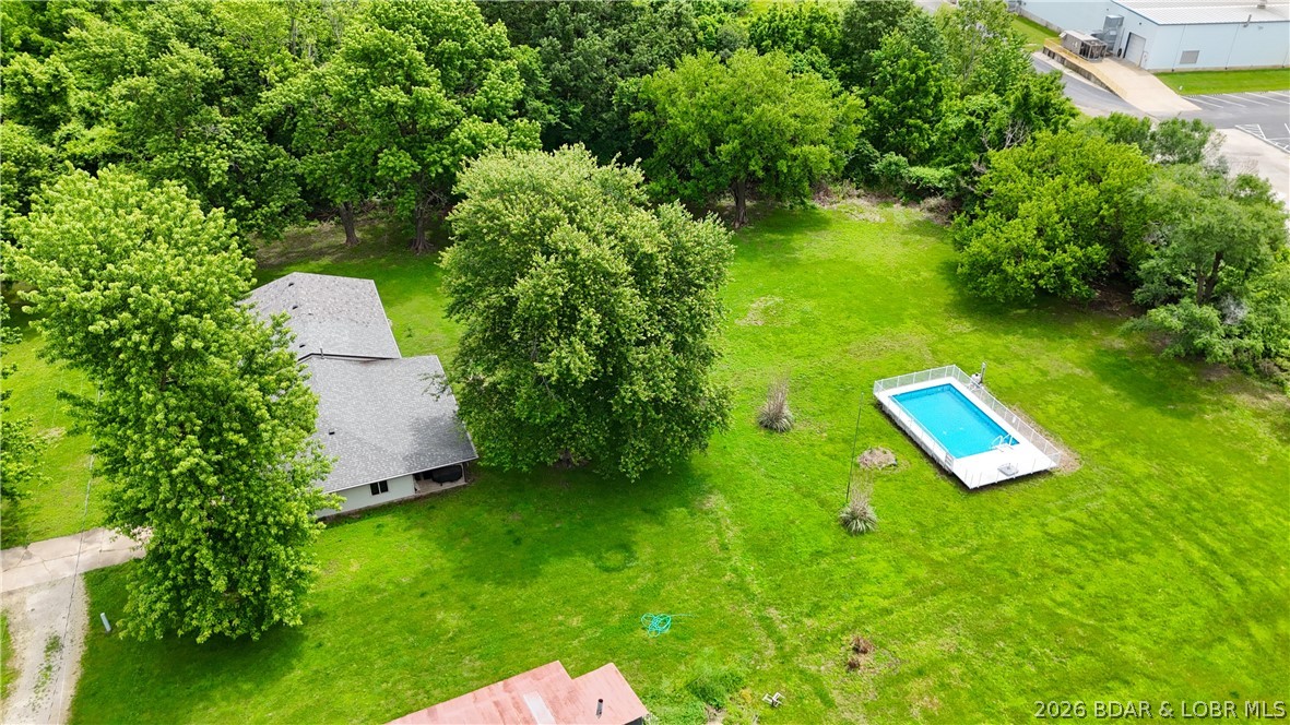 1014 Railroad Pond Rd, Eldon, MO! If energy efficiency and self-sufficiency are on your wish list, this property is a must-see. Situated on 1.5 acres with Additional Acreage Available, this beautifully renovated one-level home features 30 solar panels and a Tesla Powerwall (installed in 2026), helping reduce utility costs while providing reliable backup power. Combined with the home's efficient design, this is a rare opportunity to enjoy modern comfort with long-term energy savings. Inside, you'll find a spacious open-concept layout with a large living room, separate family room, and cozy wood-burning fireplace. The expansive kitchen offers a large island, tile flooring, and a walk-in pantry. Additional features include a huge craft room/home office, oversized laundry room with PureWash Pro, and a luxurious primary suite with a massive walk-in closet and two private bathrooms.Outside, enjoy an in-ground pool, huge covered porch, and a massive 35x50 shop with concrete floors and 3-phase electric. With city water, private septic, room to garden, and outstanding green-energy features, this property offers a unique blend of sustainability, privacy, and convenience.