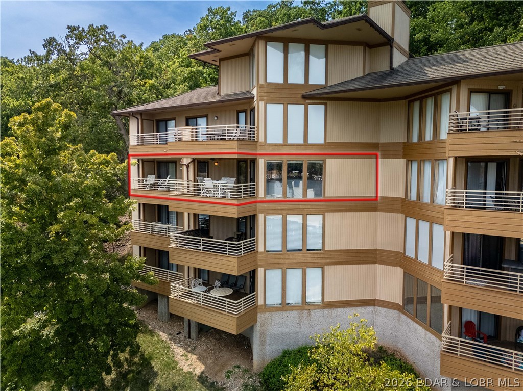 WALK-IN—NO STAIRS! Welcome to The Breakers, an intimate and meticulously maintained lakefront community with just 67 residences, ideally located at the 3 Mile Mark of the Osage Arm. From your private covered deck, take in breathtaking, unobstructed panoramic views of the Main Channel and enjoy the peaceful waterfront setting year-round. Residents enjoy exceptional amenities including a lakeside pool, tennis courts, and clubhouse, all just minutes from popular restaurants, shopping, golf courses, and everything Lake life has to offer. This spacious 2-bedroom, 2-bath condo features a wall of windows that fills the home with natural light while showcasing the spectacular views. Perfect as a full-time residence or an ideal weekend retreat, this TURN-KEY property is ready for immediate enjoyment. For cozy evenings a NEW electric fireplace will be installed June 2026.  Also included is a 12’ x 28’ boat slip and a 6,500 lb boat lift with remote, making it easy to get out on the water at a moment’s notice. Opportunities to own at The Breakers are rare—schedule your private showing today!